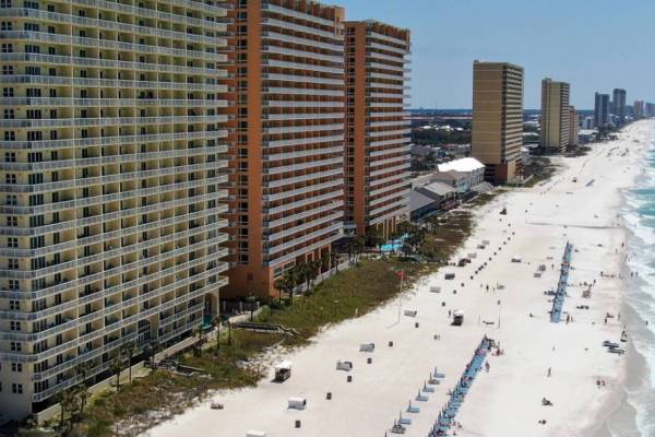 Resort buildings along the coast of Panama City Beach on a sunny day.