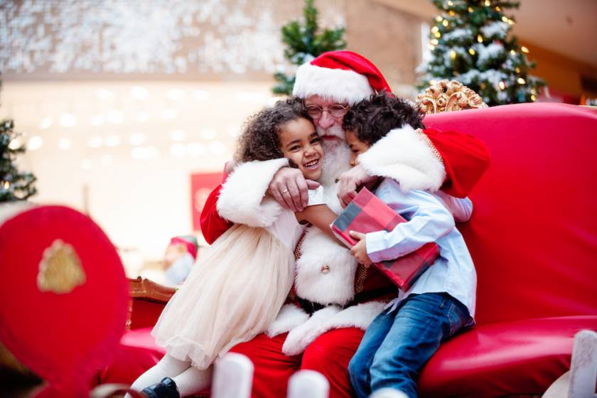 kids hugging Santa Claus